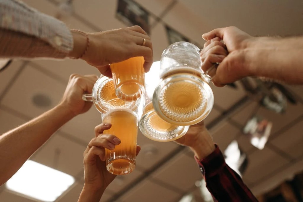 People cheering with different types of beer glasses. | Different Types Of Beer Glasses