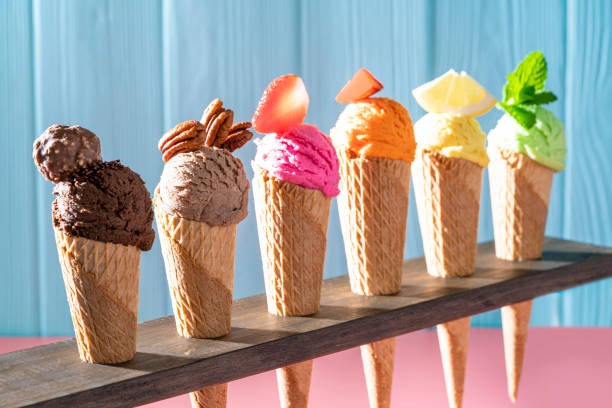 Assorted ice cream waffle cones in a row colorful different flavor. 